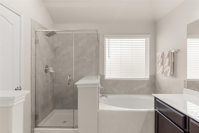 bathroom featuring separate shower and tub, plenty of natural light, vanity, and lofted ceiling