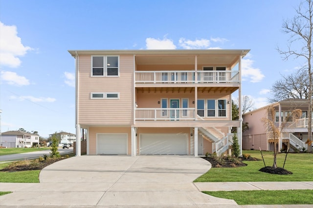 view of front of house with a garage, a balcony, and a front lawn