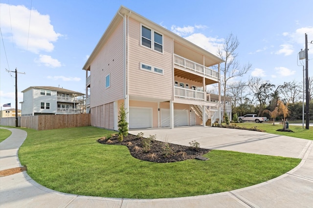 view of side of home featuring a garage, a lawn, and a balcony