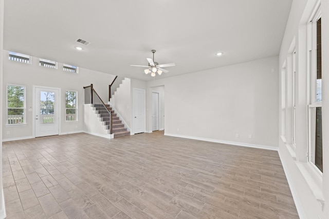 unfurnished living room with ceiling fan and light wood-type flooring