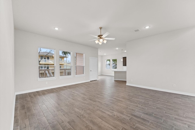 unfurnished living room featuring hardwood / wood-style floors and ceiling fan