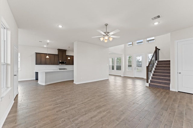 unfurnished living room with ceiling fan and light hardwood / wood-style flooring