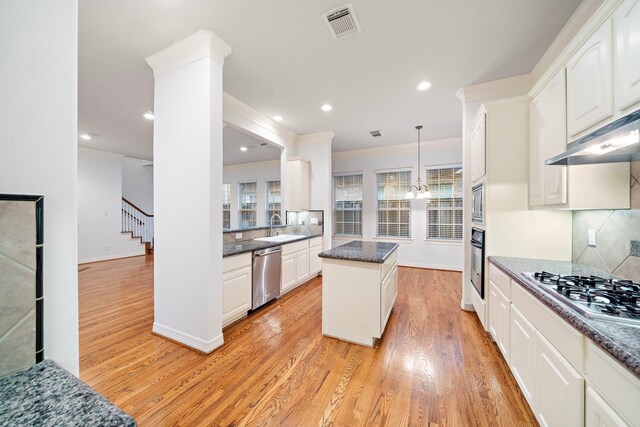 kitchen featuring sink, white cabinets, light hardwood / wood-style flooring, and appliances with stainless steel finishes