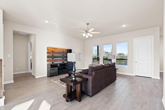 living room with light wood-type flooring and ceiling fan