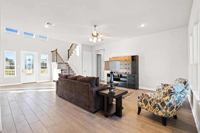 living room with ceiling fan and light hardwood / wood-style floors