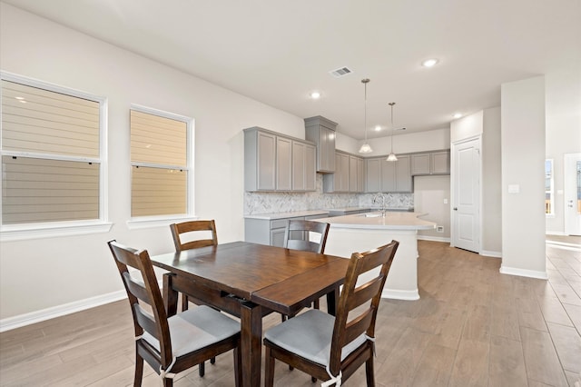 dining area with sink and light hardwood / wood-style flooring