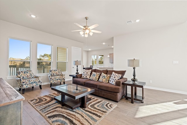 living room featuring ceiling fan and light hardwood / wood-style flooring