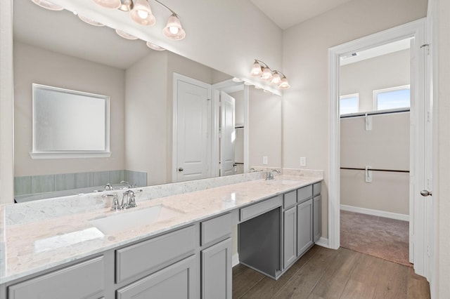 bathroom featuring vanity, hardwood / wood-style flooring, and a bathtub