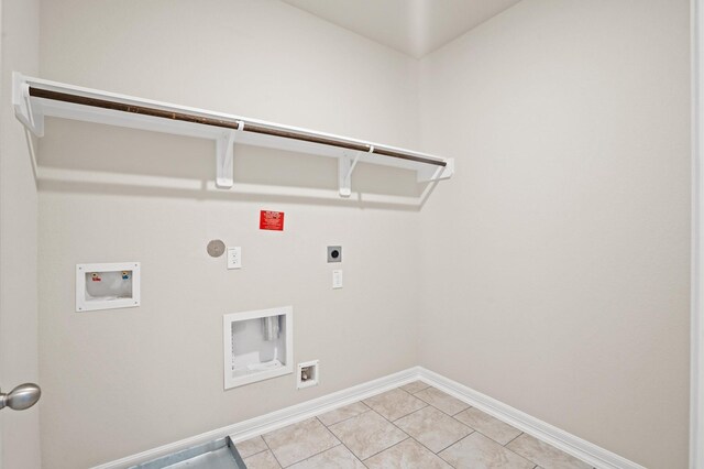 washroom with hookup for an electric dryer, gas dryer hookup, light tile patterned floors, and hookup for a washing machine