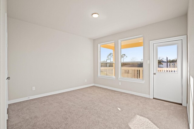 empty room featuring light colored carpet