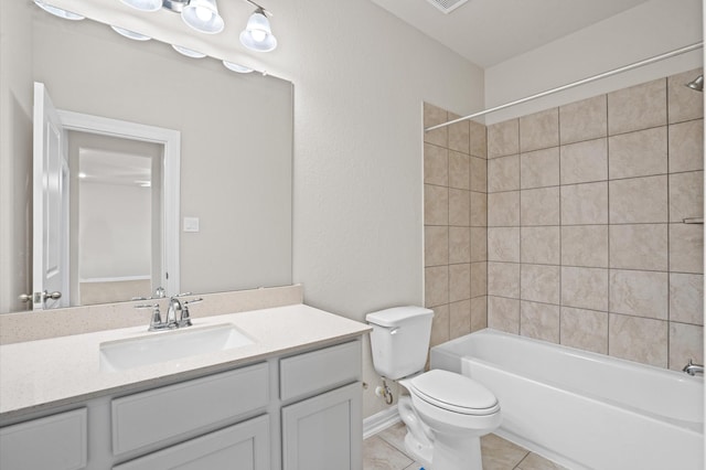 full bathroom featuring tile patterned flooring, vanity, tiled shower / bath combo, and toilet