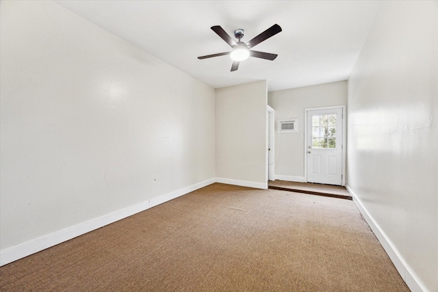 carpeted spare room with ceiling fan and an AC wall unit