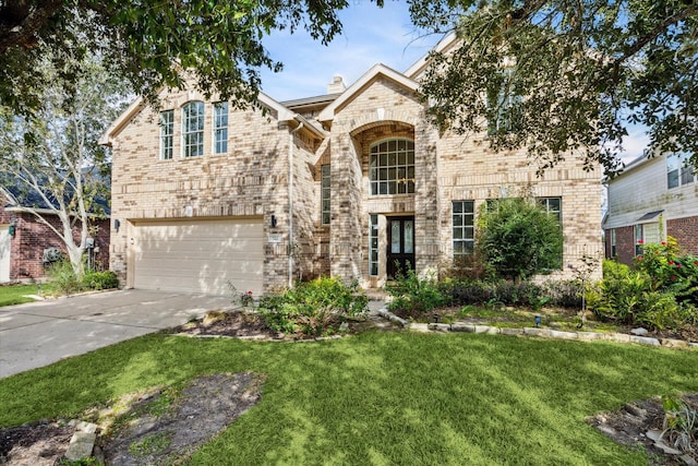 view of property featuring a front lawn and a garage