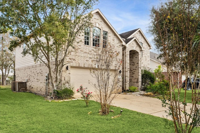 view of front of property with central AC unit, a garage, and a front yard