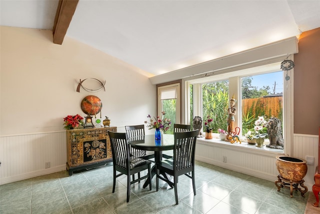 dining area with lofted ceiling with beams