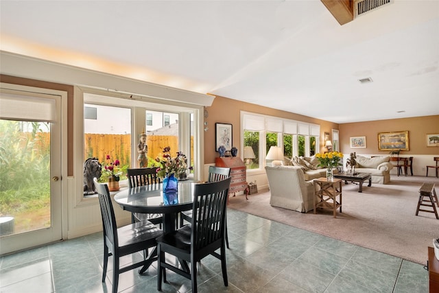 dining area featuring light colored carpet