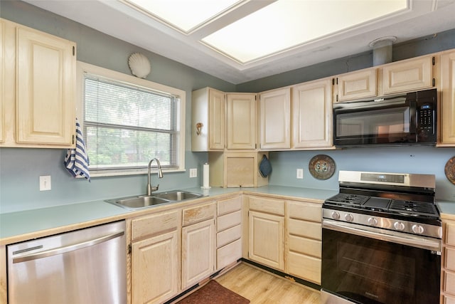 kitchen with light brown cabinetry, sink, appliances with stainless steel finishes, and light hardwood / wood-style flooring