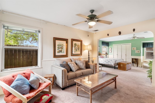 living room featuring carpet flooring and ceiling fan