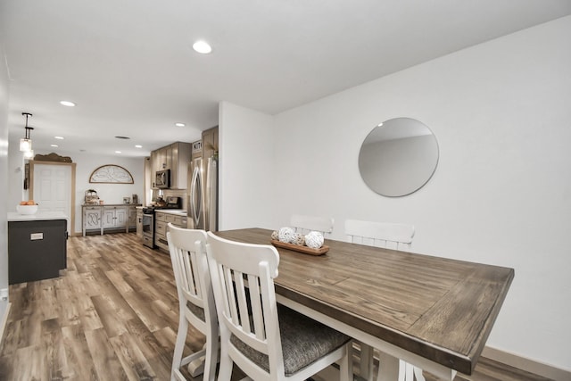 dining space featuring light wood-type flooring