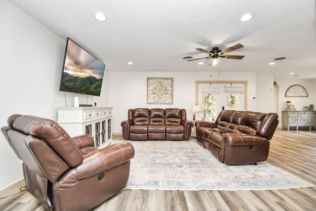 living room with ceiling fan and light hardwood / wood-style floors