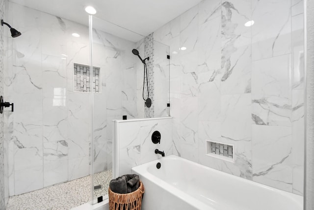 bathroom featuring separate shower and tub