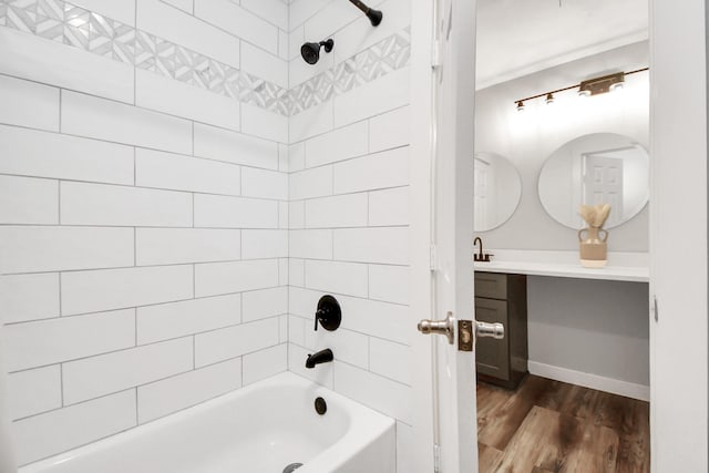 bathroom with vanity, tiled shower / bath, and hardwood / wood-style flooring