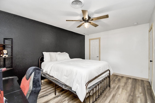 bedroom featuring hardwood / wood-style flooring and ceiling fan