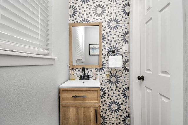 bathroom with vanity and tile walls