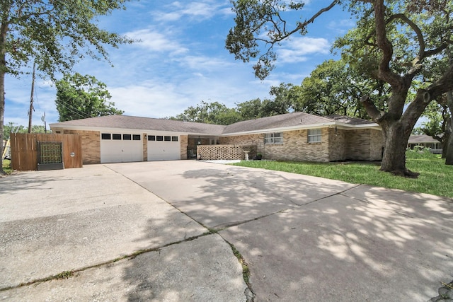 ranch-style home with a front lawn and a garage