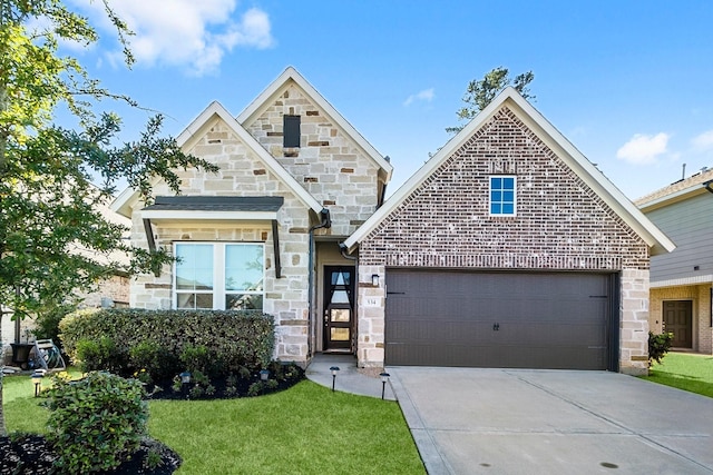 view of front of property with a front yard and a garage