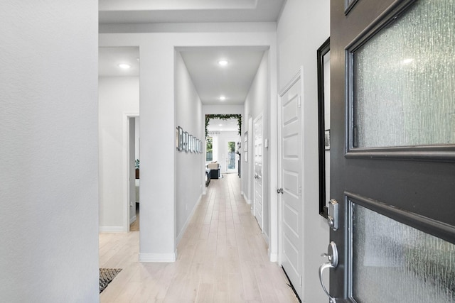 hall with light hardwood / wood-style floors