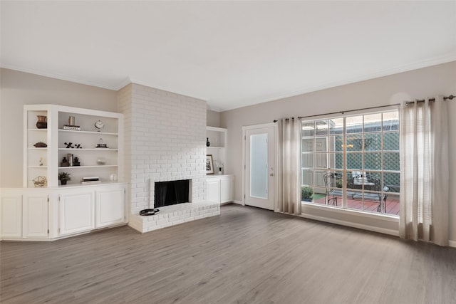 unfurnished living room featuring a fireplace, light wood-type flooring, and crown molding