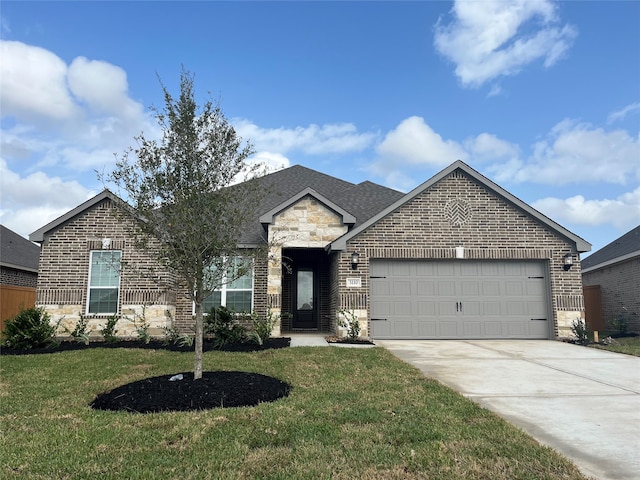 view of front of home with a garage and a front lawn