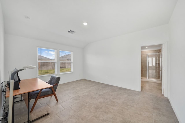 office space featuring light tile patterned floors and vaulted ceiling