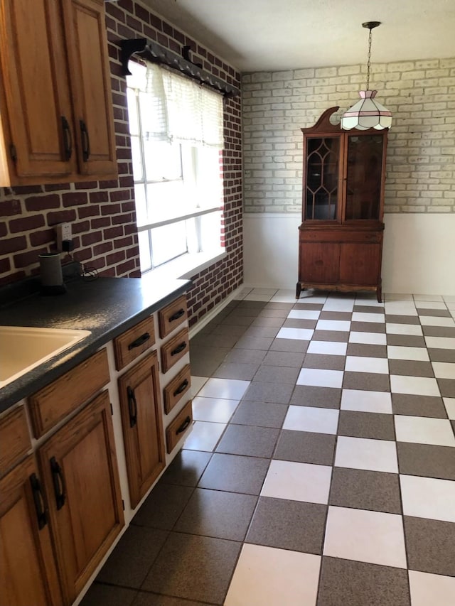 unfurnished dining area with brick wall