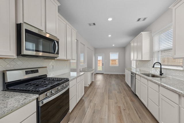 kitchen featuring white cabinets, stainless steel appliances, and sink