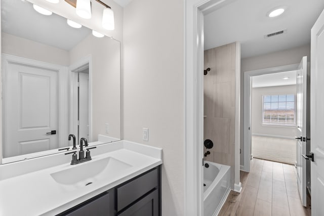 bathroom featuring shower / tub combination and vanity