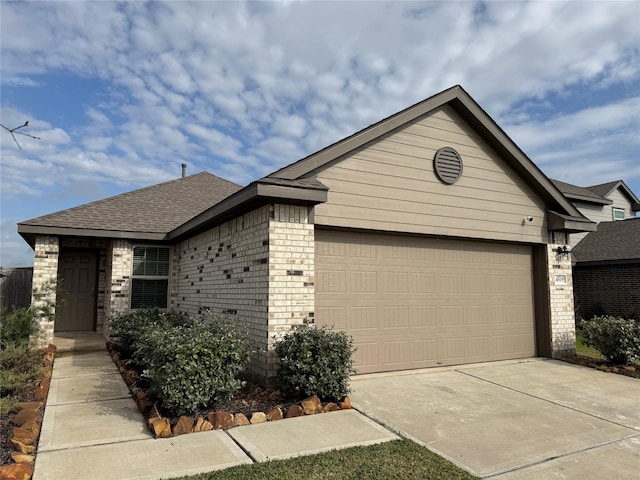 single story home with a garage, driveway, brick siding, and a shingled roof