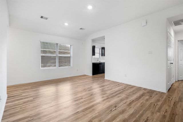 14519 Broadbury Pond Rd, Rosharon, TX 77583 - unfurnished living room featuring light wood-type flooring, baseboards, recessed lighting, and a sink