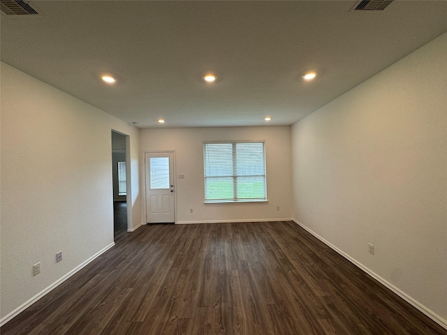 empty room with dark hardwood / wood-style flooring