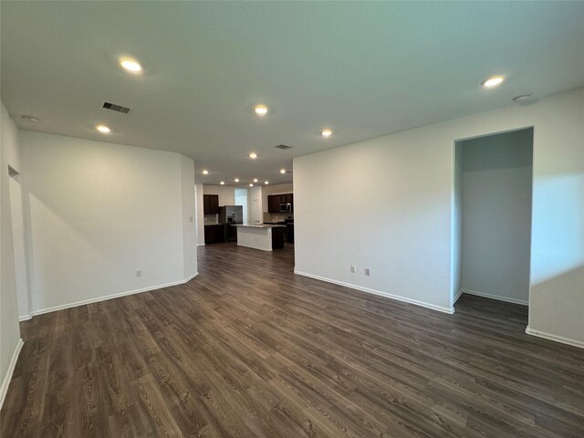 unfurnished living room featuring dark wood-type flooring