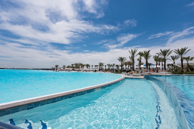 view of swimming pool featuring a water view