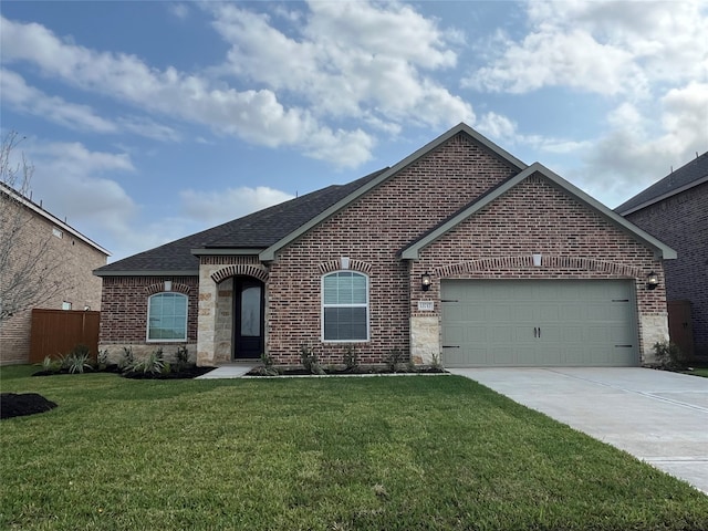 view of front of home featuring a front yard and a garage