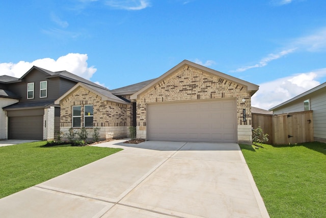 40738 Rosemary Rain Ln, Magnolia, TX 77354 - view of front of home with concrete driveway, a garage, a gate, and brick siding
