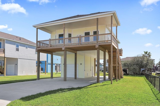 22805 Miramar Dr, Galveston, TX 77554 - back of house with an attached garage, driveway, a wooden deck, roof with shingles, and a carport