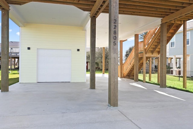 garage featuring a yard and a carport