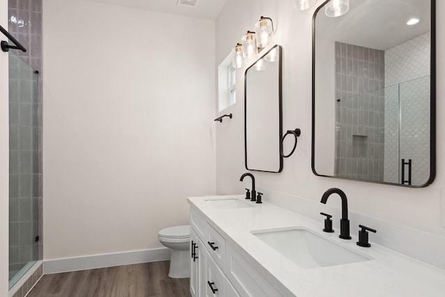 bathroom with vanity, wood-type flooring, an enclosed shower, and toilet