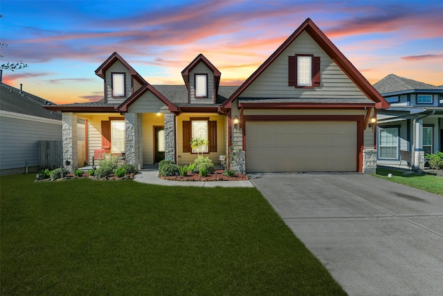 view of front of home featuring a garage and a yard