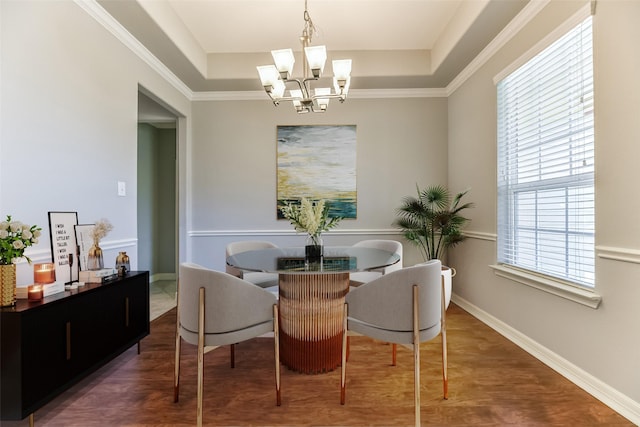 dining space featuring dark hardwood / wood-style flooring, a raised ceiling, and an inviting chandelier