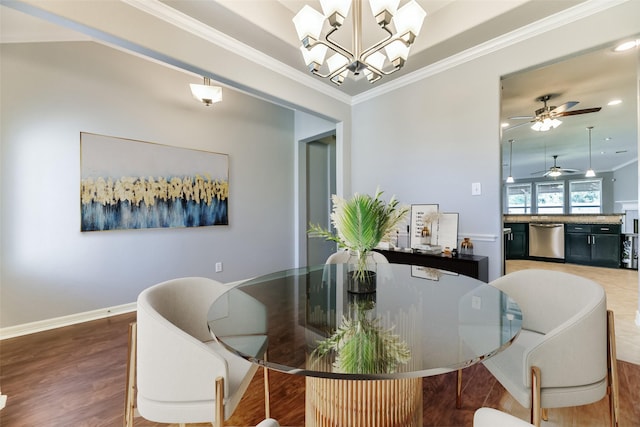 dining room featuring ceiling fan with notable chandelier, ornamental molding, and hardwood / wood-style floors